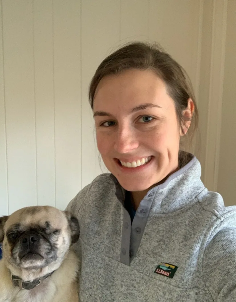 Dr. Melinda Atherton's staff photo from Media Veterinary Hospital where she is taking a selfie photo of herself with her pug dog.